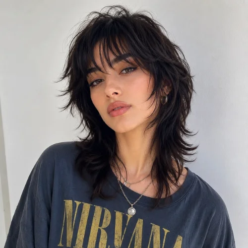 Stylish wolf cut hairstyle for women with layered bangs and textured volume for a modern, effortless look.